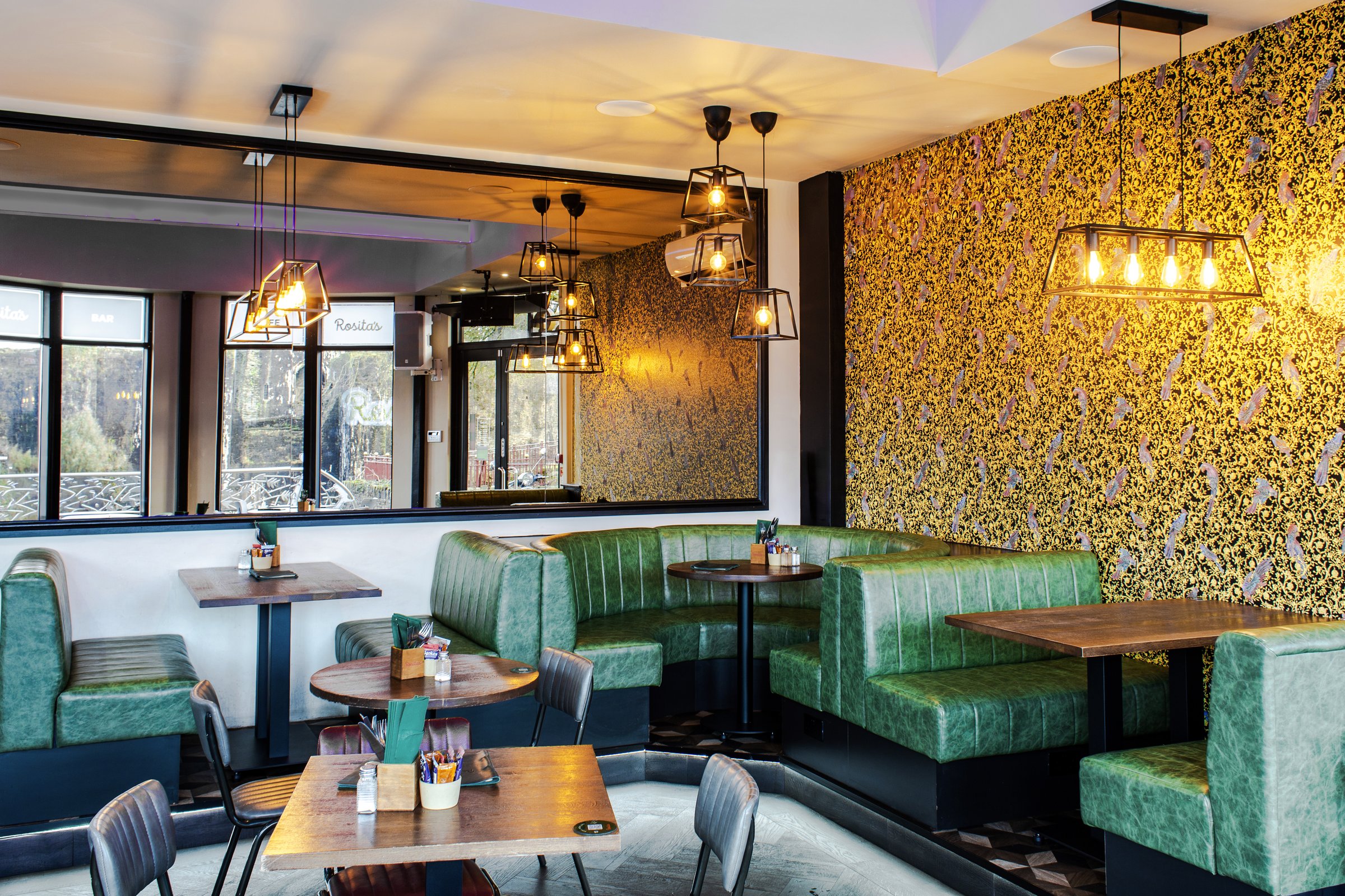Green booth seating and pendant lights at Rosita's Cafe Bar, Caerphilly